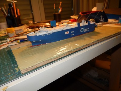 After applying the first thicker coat and cutting out the profile, I placed the ship and applied a second coat, with a slightly different colour mixed in. This will make the blue coat nearly invisible and create some depth along the way.