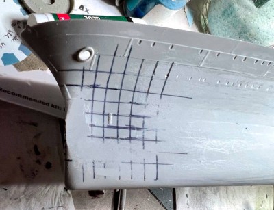 A lot of plastic was removed at the extreme bow to straighten out the profile.  The area where the sharpie grid remains is the dent.