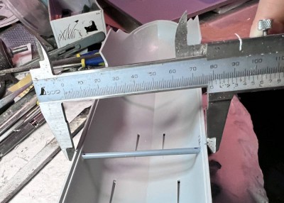 Here I'm fitting a brace in place.  I set the caliper when the hangar deck part was in place.  Then I adjusted the fit of the brace so that the hull width fits the caliper.