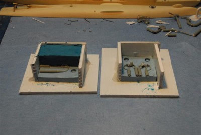 This shows the molds ready for the second half pour.  They are coated with brush on mold release. The one on the left is a failed attempt to make a three part mold of the gun barrels.