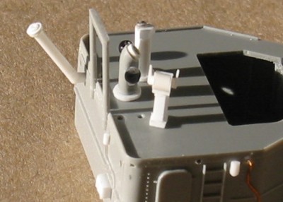 Hard to find any clear photos of the details in this area.  Revell completely ignored this equipment so I scratch built it from styrene, spares, and beads.  From the few photos available to me I can tell there is a engine telegraph, a binnacle in the center, and something else on the other side.  Anyone know what this is or have a photo?  Note the antenna trunk, also ignored by Revell.