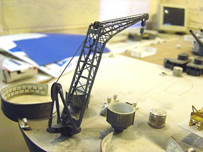 Here we have the aircraft crane. This is also p/e brass from Tom's Modelworks. Not to knock their products, but I find them too thin. The crane consists of 7 pieces. The sideframes were beefed up with .040 sq. styrene to stiffen the structure. The base is another JR Haynes product and is cast metal consisting of 8 pieces and is very well done.The pulleys and the hook are styrene that I fabricated. A bit more rigging has to be finished here.
