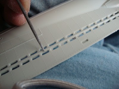 A round needle file worked great in taking the excess down.