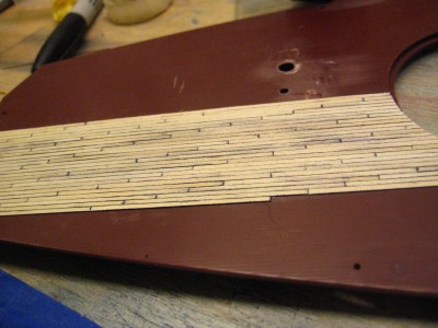 I let the planks overlap into the recesses in the deck, they are very eqsy to cut once glued down.