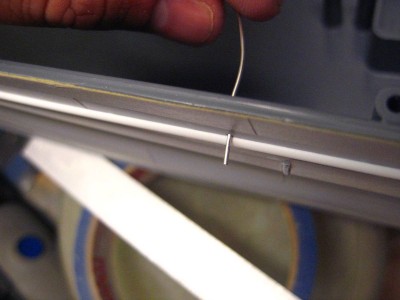 thin soldering wire fed through, worked like a charm.