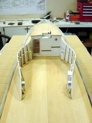 I have added the deck planking which is 1/32" scribed basswod. This was overlaid on the previously fabricated 1/16' balsa deck, using hi-strength contact cement. Note the spray shields.