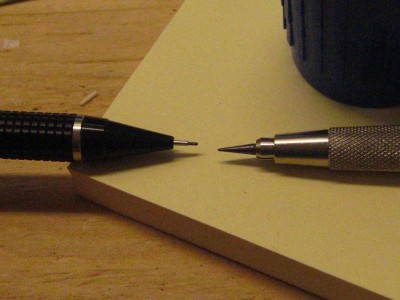 comparison of mechanical pencil on left to drafting pencil on right. These were what produced the 2 attempts at hull plating.
