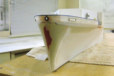 DSC04159.JPG (139.71 KiB) Viewed 4361 times The CVE's bow has now been formed in again using the body filler. Note the bulwark, fabricated from .010 styrene then blended into the hull with the filler. The red spot you see is the glazing putty I spoke of. Sort of like very thick primer, almost a paste. Some of the hawse lips have been added. "Cap" on top of bulwark is thin telephone wire.