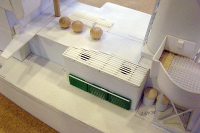 Vegtable storage cooler here. Note the condenser tubes and fans on the roof. Louvers are doctored up lego parts. Note the garbage cans just to the right.