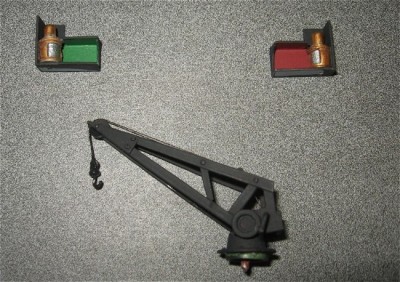 The navigation lights and anchor crane are cast resin fittings. Here they are painted ready for installation.