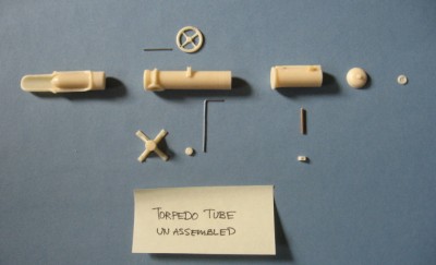 The torpedo tube components, removed from their casing base.