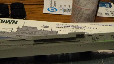 This is Part C-17, which the instructions tell you to add as one of the very last bits. This is after the flight deck is cemented and you're putting the island on. Unfortunately, following the instructions as written would make it exceedingly difficult to mask off the flight deck effectively, so that you get the Deck Blue surrounded with Haze Gray, for the final color scheme. It also makes it a heck of a lot easier to paint the horizontal surfaces of the hangar level, forecastle, and fantail prior to permanently attaching the flight deck and island. Test fitting has confirmed that the process will work.