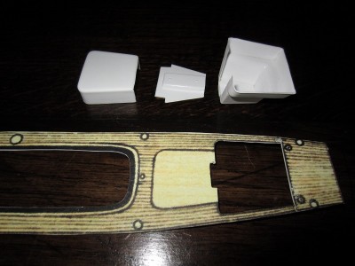 The plastic card deck with some of the main apertures cut out.