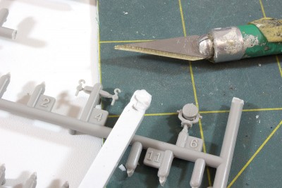 I've carved the tarp covered light on the end of a strip of Evergreen sprue. The sprue is a good handle. I carve notches and folds for my caenis thread that will come later.