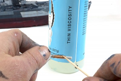 While holding the wire, touch it with some thin CA glue.  This will bond everything in place.