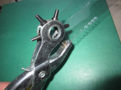 A hole punch was used to create small port hole glazing discs from some acetate packaging.