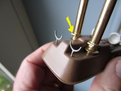 The funnel hinges are arrowed at the base of the funnel. The hinges face forward.