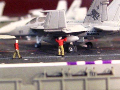 Ordnance tech checking a widget on a pylon.