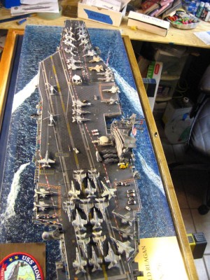 The final layout, everythign you see is NOW glued firmly in place.  the empty area behind  and starboard of the bow hawkeye is where the C-2 and prowlers will be.
