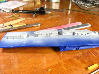 I can now mask the individual components for the deck gray, and then start assembling the deck houses.