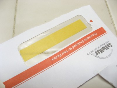 Junk mail has its uses: strip of Tamiya 1" wide masking tape stuck to the clear envelope address window. In the past I've also used wax paper, aluminum foil, or clear takeout food container lids.