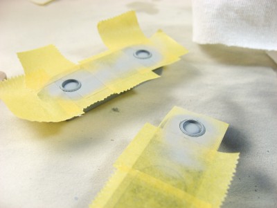 I cut the circles in half before peeling the tape from the plastic. For each pedestal I needed three pieces of half-circle tape, because of the size issue. Place them against the circular object so that there's minimal gap, and use as many half-circles as you need. I then airbrushed from the side using low pressure and extremely thin paint (something like 5psi).