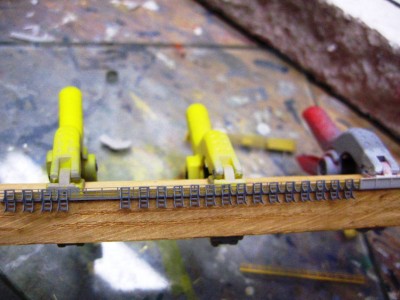 the spacing needed between each canister rack is slightly bigger than the spacing of the stanchions of the rails.  Of course it could not be as simple as a perfect one-stanchion spacing arrangement.