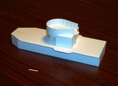 Roughing out the aft deckhouse and aft-most twin Bofors position.  The bulkheads and decks are cut from .040 Evergreen styrene.  Stiff .040 sheet is good for structural components resisting any tendency to warp.  The splinter shields are cut from .020 sheet.  The corners of the upper structure are rounded on the real ship at the joint.  The model's will be rounded later.  The small styrene piece is one of the splinter shield reinforcements not yet installed.  The locations for the reinforcements are marked in pencil on the shield before the shield is glued in position.  The open end of the Bofors position will be filled by a cylindrical Mk-51 Director platform.