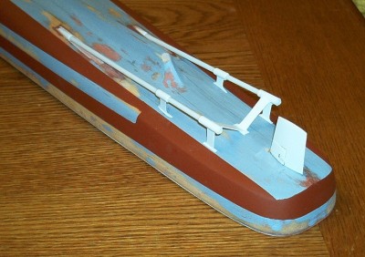 You can see here two strakes of raised plating are painted with others yet to be done.  I use automotive red primer sprayed from a can.  It's tough and has the right "red lead" look.  The strakes were masked with Tamiya masking tape (really good stuff but pricey).