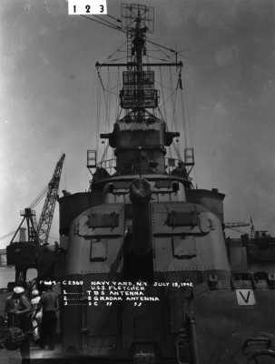 The real gunhouses were asymmetrical; the gunhouse is larger on one side to accommodate the additional crew on that side (the fuse time-setting mechanism was on just one side of the gun and thus the crewmen who set the fuses needed additional space to work).  The centerline of the barrel, however, is exactly above the centerline of the barbette.