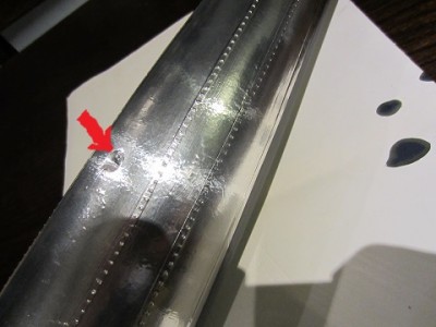 Here is the plating on the underside of the hull plug. The arrow indicates one of the two screws temporarily holding the two halves together.