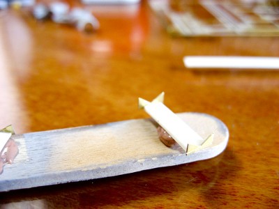 The styrene base is way too thick, but mostly hidden by the boats once mounted. I briefly considered tearing this apart and replacing the center piece with a section of ladder, but it was so frustrating to make this simple little assembly that I decided to quit while I was ahead.