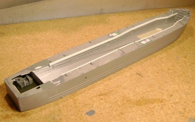I used .060 x .125 inch styrene strips glued to the tank well bulkheads to provide a raised surface about .030 inch above the level of the existing deck.