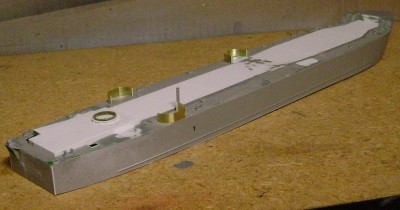 A view from aft starboard.  You can see the first step in installing the stern anchor platform in this shot. The kit represents an early LSM; on the early LSMs, the platform was lower.  This configuration was changed on later LSMs.  It is relatively easy to modify this on the kit, though.   More on that later.  I've also added a coaming of .005 inch styrene around the aft starboard ladder opening.  This is not represented on the kit.  I've also begun adding topside details, such as the smoke stack and bitts.