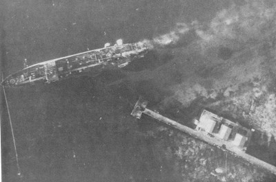 Fujisan Maru sinking, Dublon Island oil terminal wharf, Truk, morning , 17 February, 1944.jpg